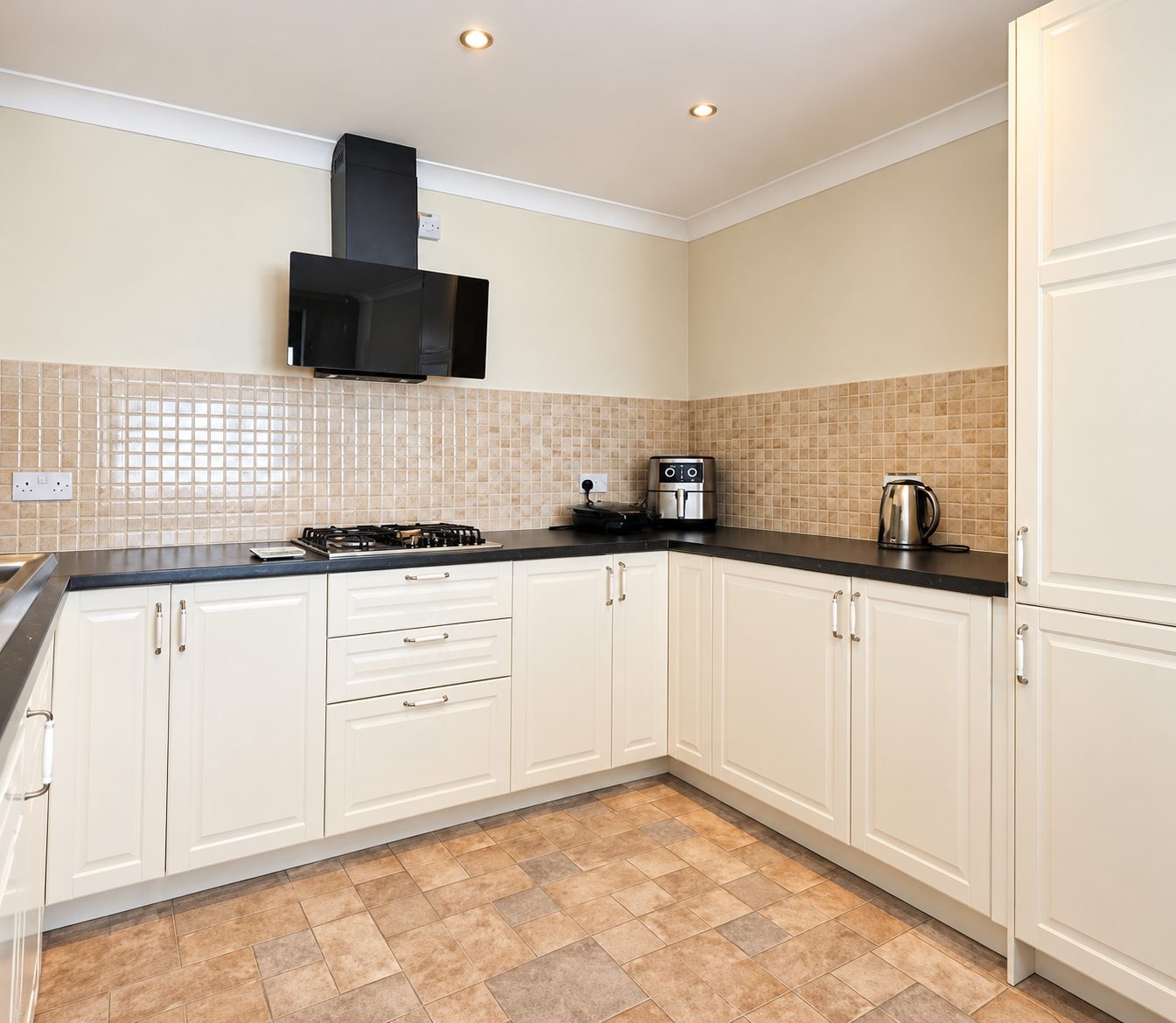 Cream kitchen with black worktops